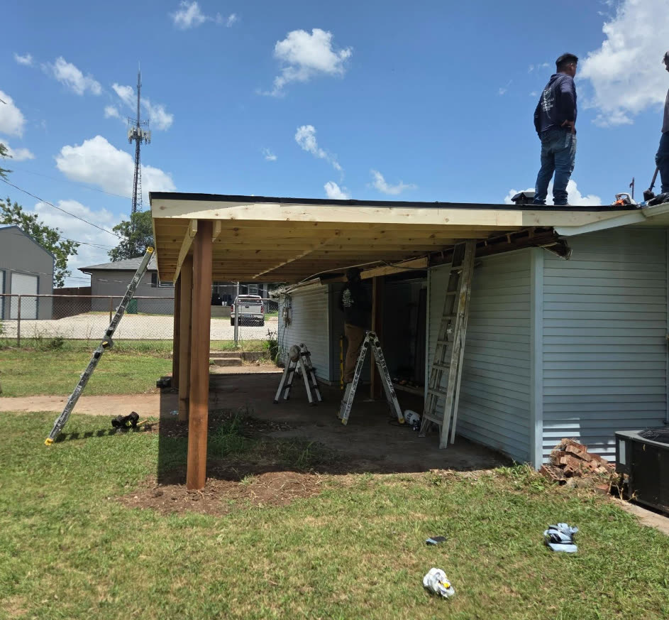 Crew framing a new covered porch on a house